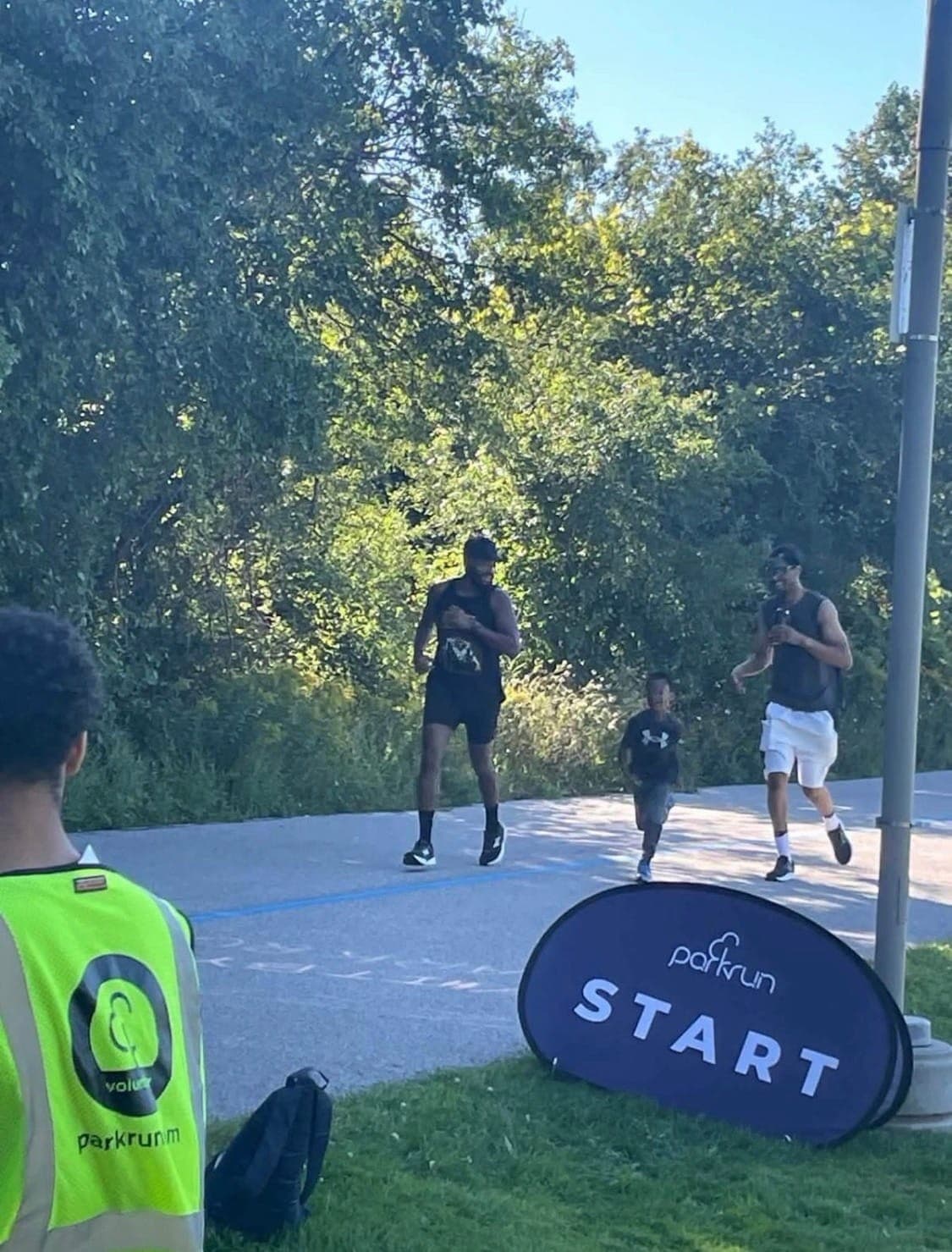 Acts House runners crossing the start line of a Saturday morning parkrun.